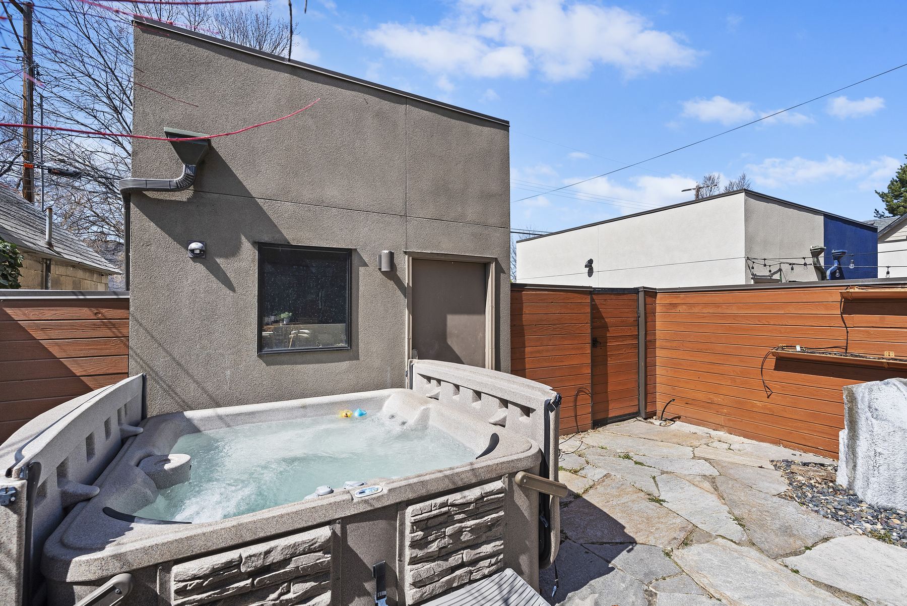 Private hot tub in a fenced courtyard at a Boise North End vacation rental