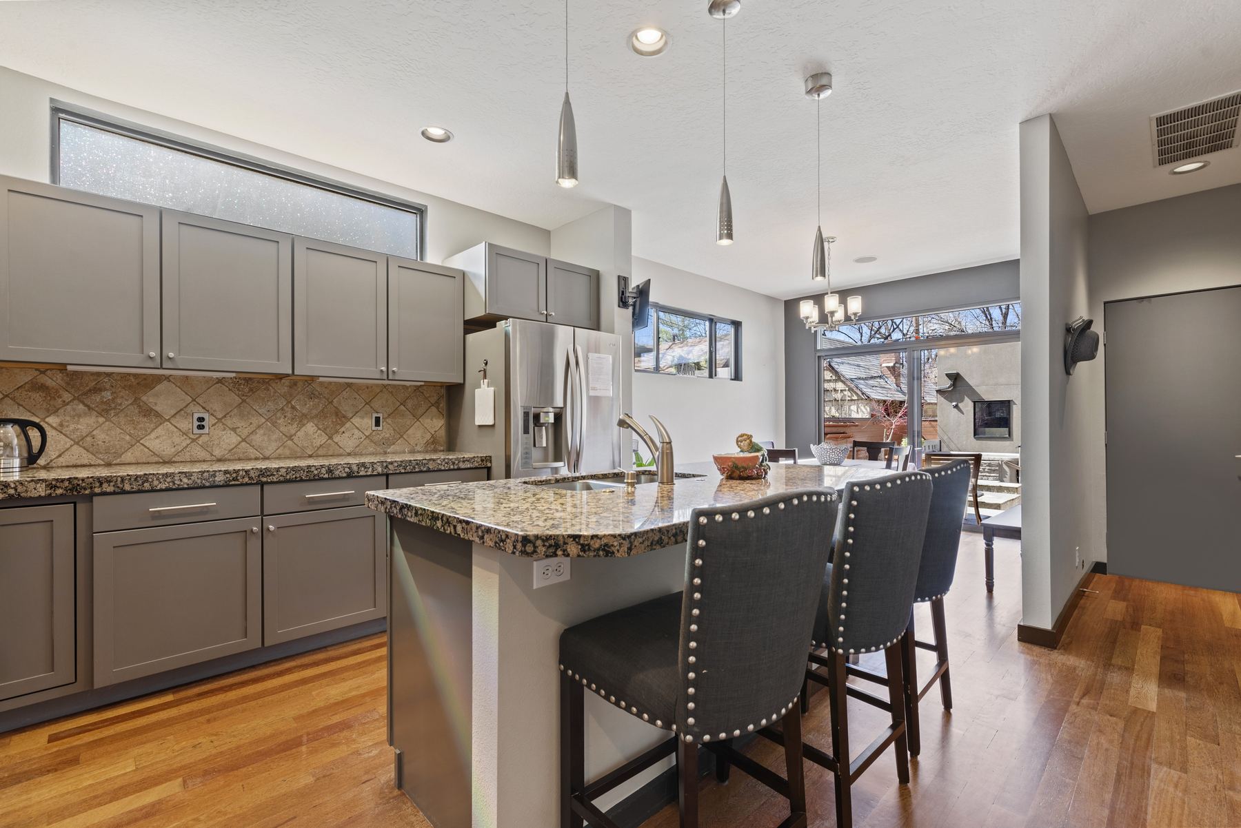 Kitchen with granite island and bar seating at a Boise North End vacation rental